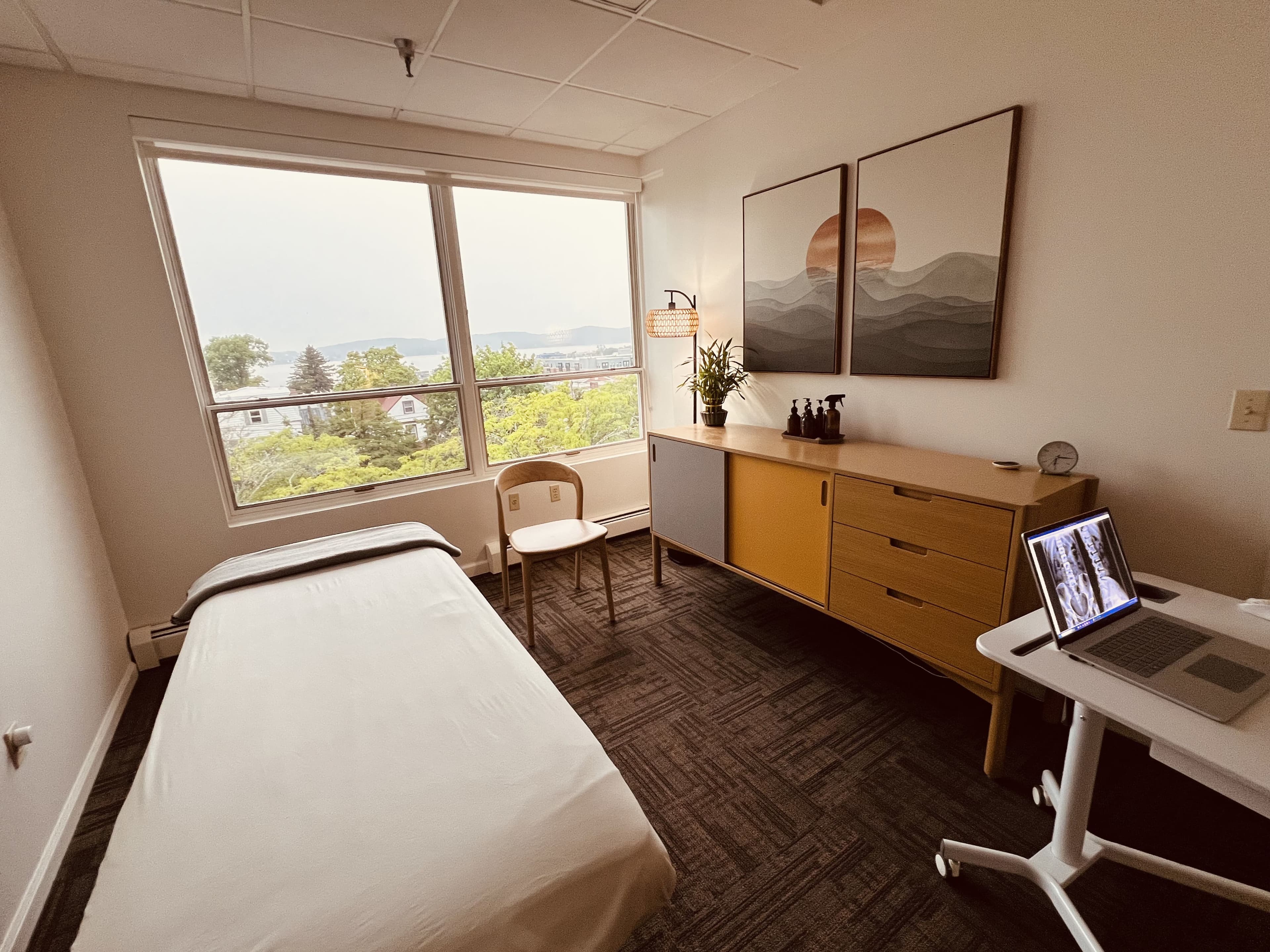 Treatment room with a table and framed prints