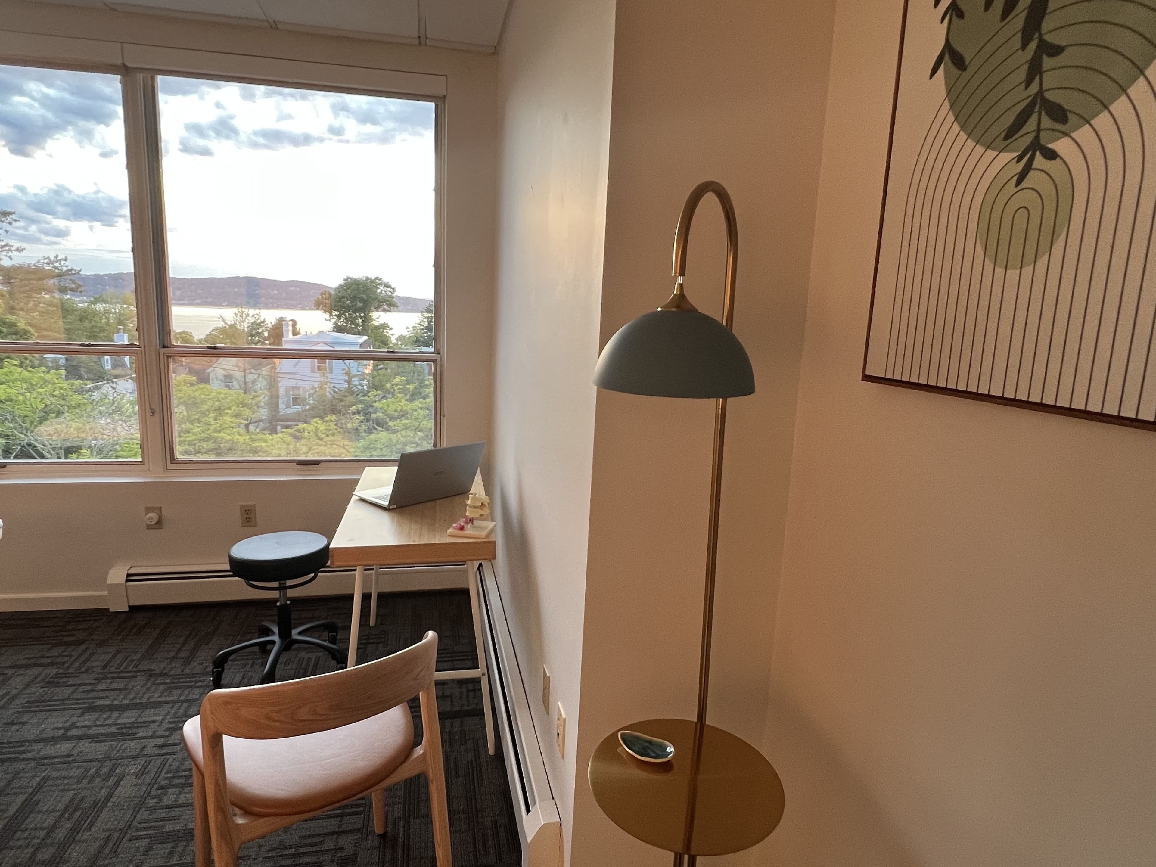 Desk, chair and floor lamp by a window