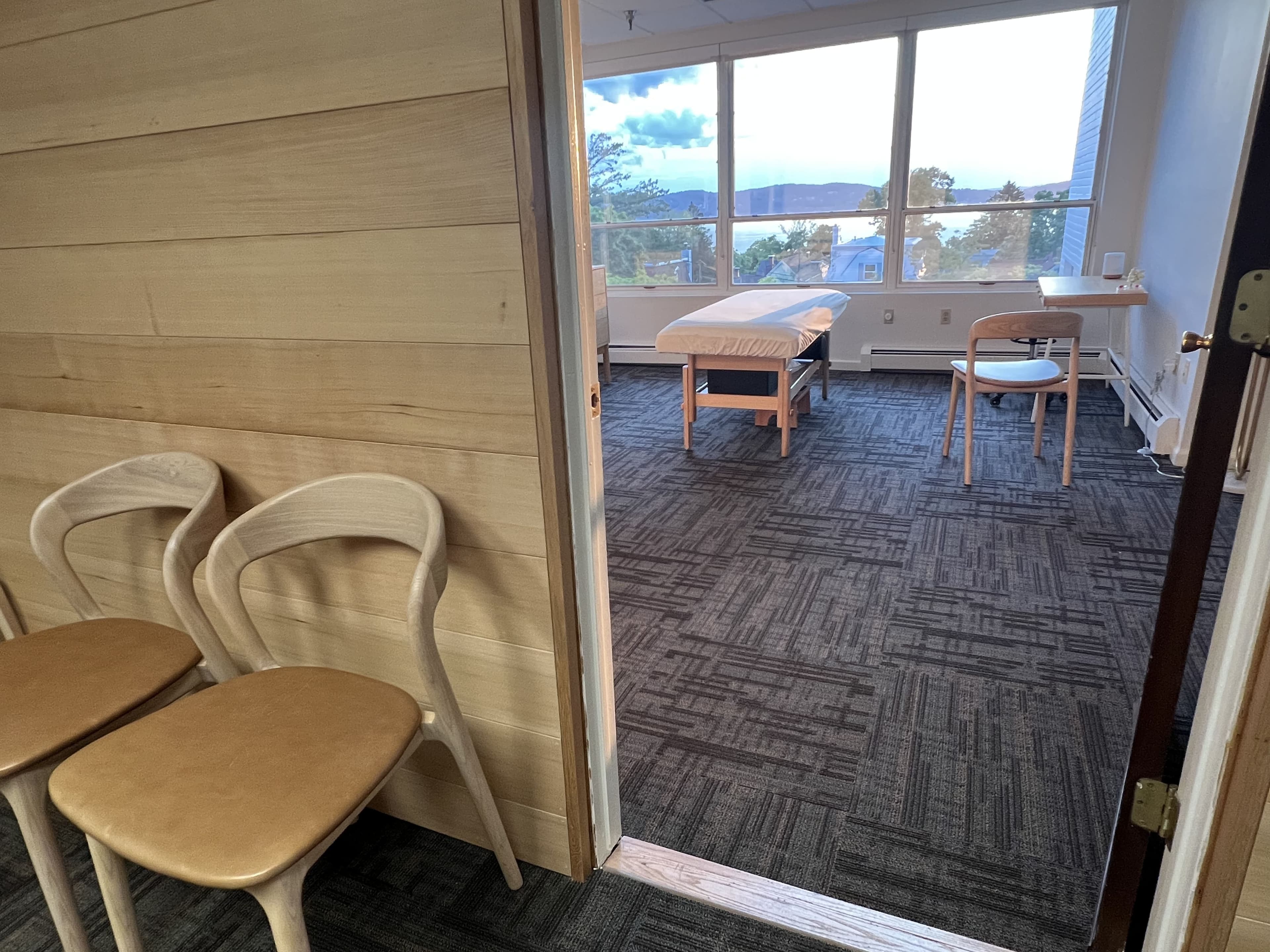 Waiting chairs by a treatment room door