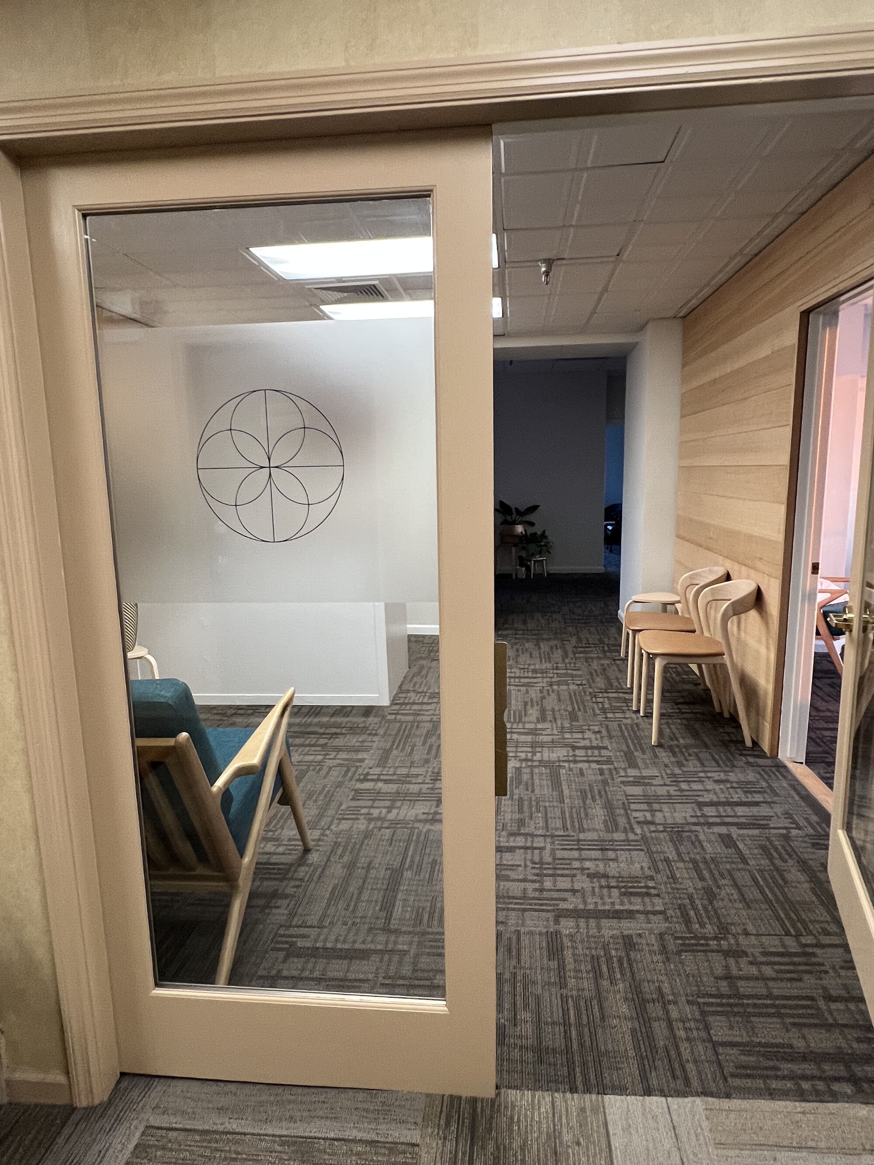 Glass door to the clinic with the rosette logo