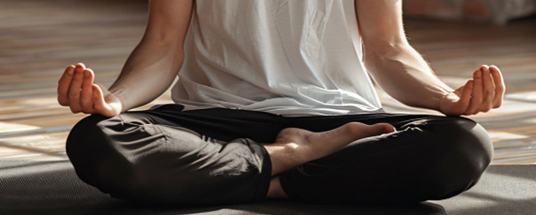 Person seated cross-legged in meditation